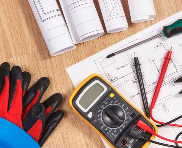 Multimeter resting on electrical diagrams