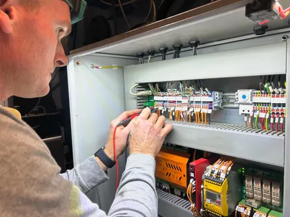 Fused Electrical Co electrician wiring a control panel