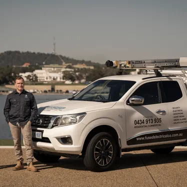 Nicolas and Andre Menager of Fused Electrical Co with their work ute beside Lake Burley Griffin